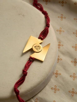Suhani Pittie Gold Plated Triangular Rakhi With Ganesha