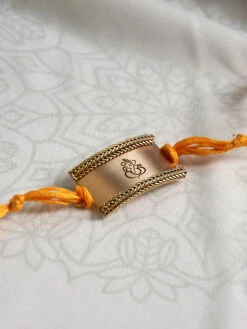 Suhani Pittie Gold Toned Rakhi With Ganesh Design