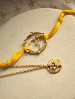 Suhani Pittie Gold Toned Rakhi And Lumba Combination With Om Motif